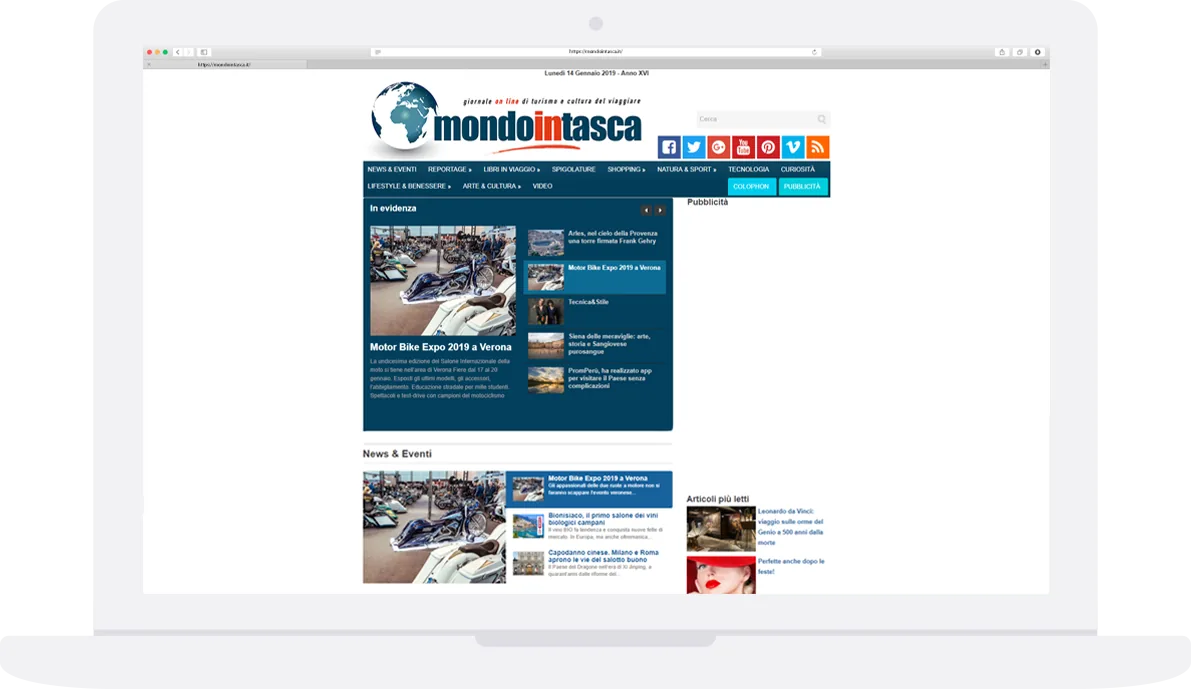 Laptop showing the home page of the Mondo in Tasca travel magazine