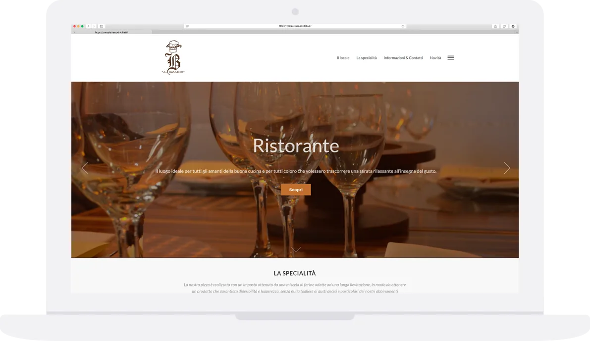 Laptop showing the Pizzeria da Bassano home page and wine glasses